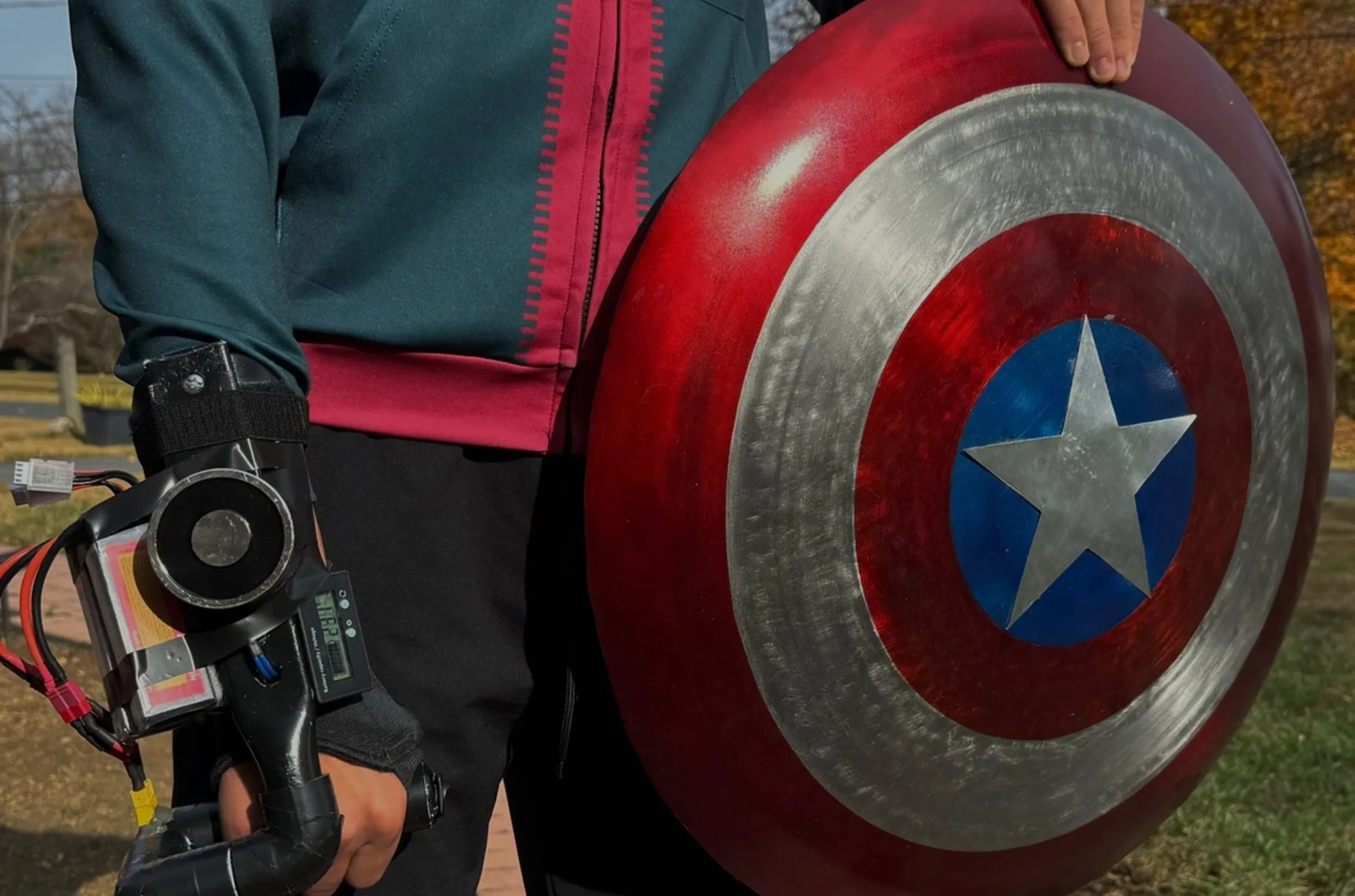A refinished Captain America shield held against a PVC electromagnet gauntlet.