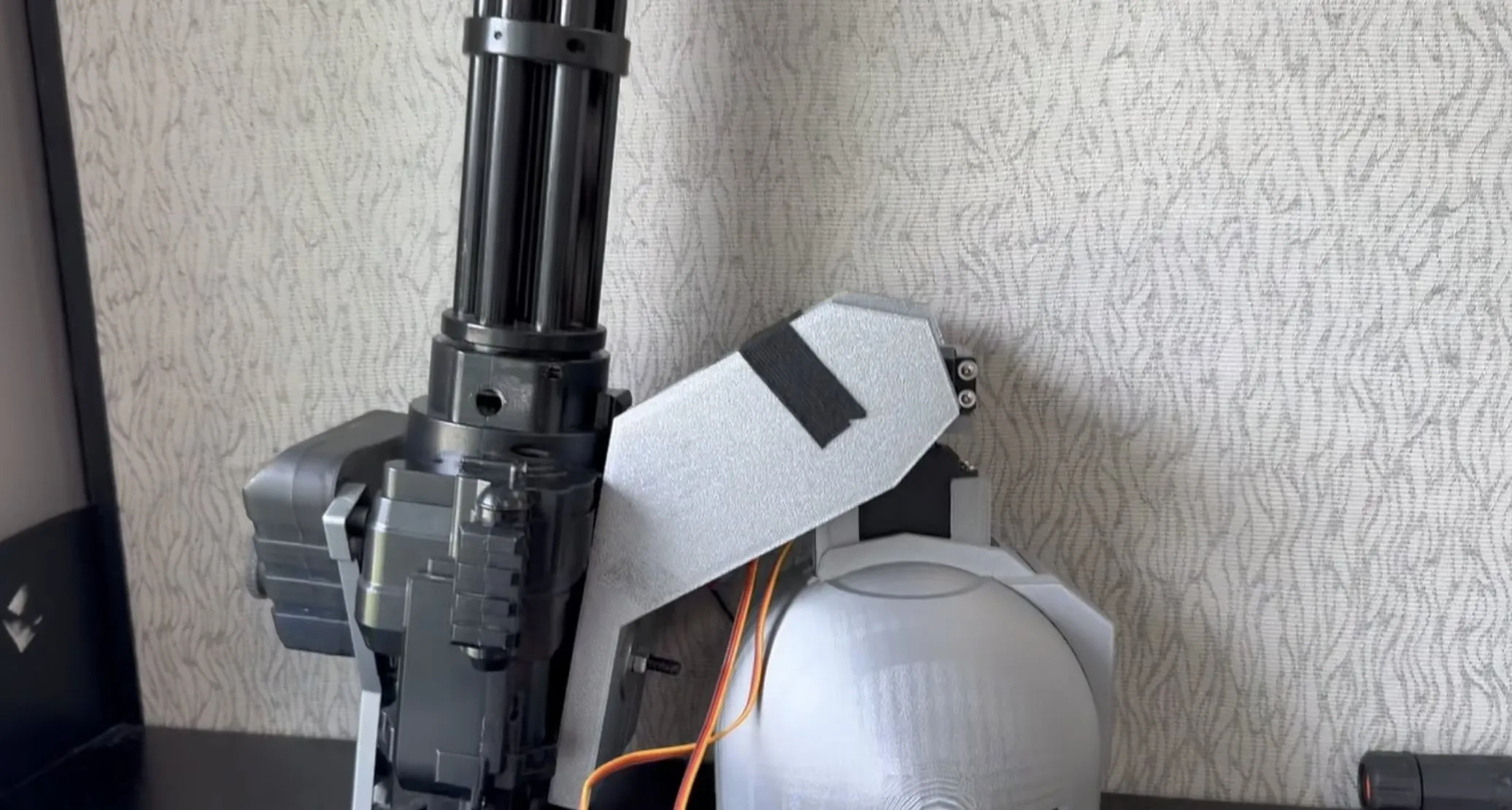 The turret prototype, with a rotary barrel on a servo pan-tilt mount beside a 3D-printed shoulder dome.